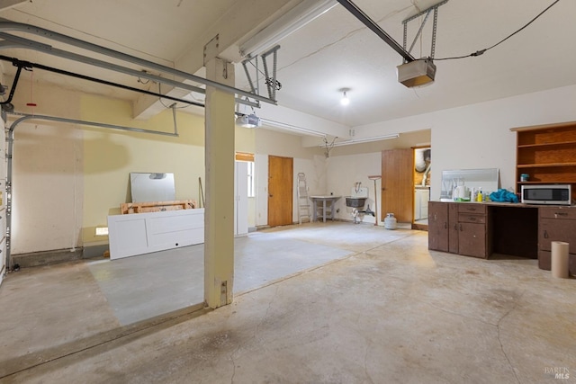 garage with a garage door opener and washer / dryer
