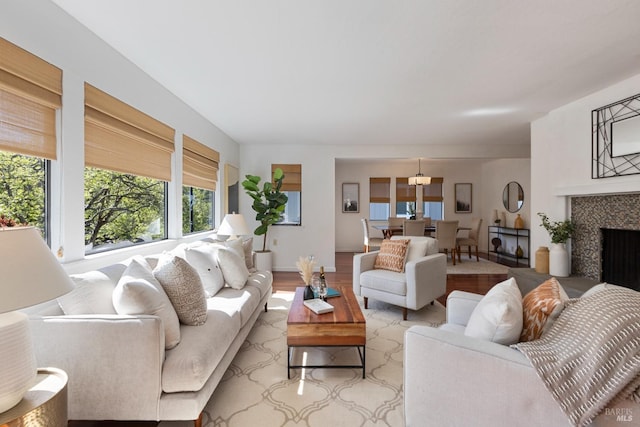 living room with a fireplace, wood finished floors, and baseboards