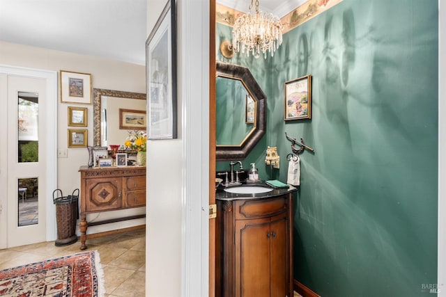 bathroom featuring tile patterned flooring, vanity, and an inviting chandelier