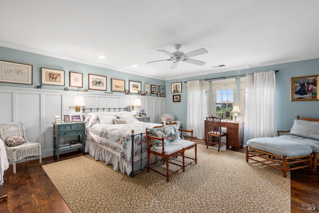 bedroom with wood finished floors, visible vents, and ornamental molding