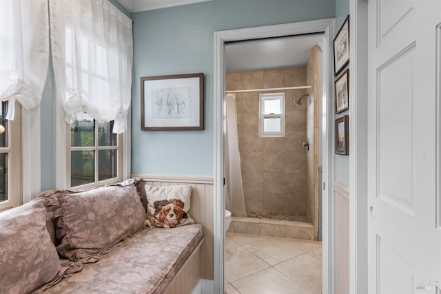 bathroom featuring a shower stall, toilet, and tile patterned floors