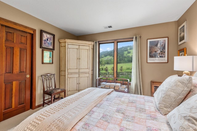 carpeted bedroom featuring visible vents