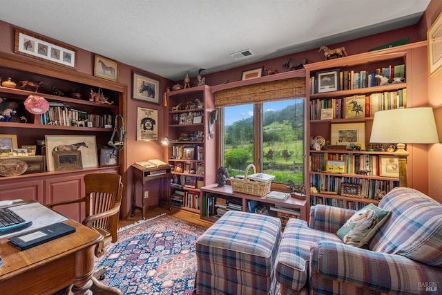 sitting room with wood finished floors and visible vents