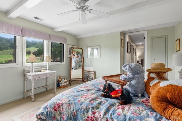 carpeted bedroom with beam ceiling, baseboards, ceiling fan, and visible vents