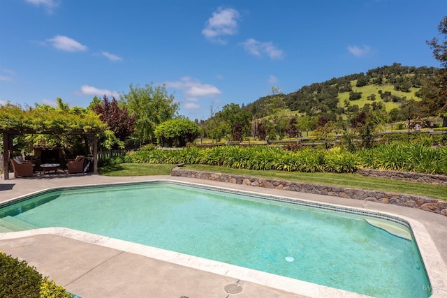 pool with a gazebo, a mountain view, and a patio