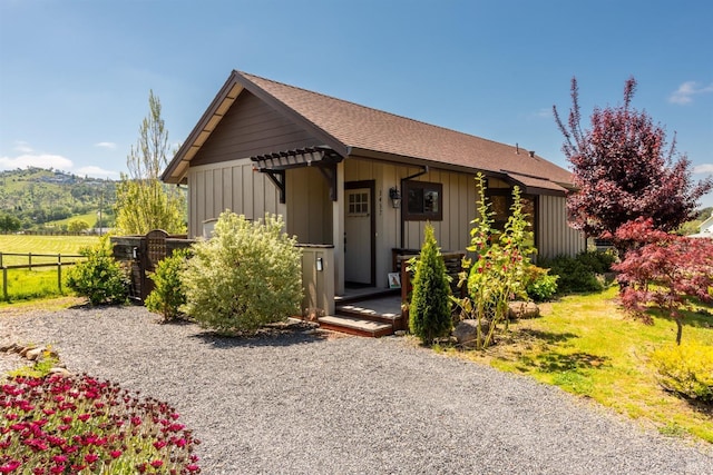 ranch-style house with board and batten siding and fence