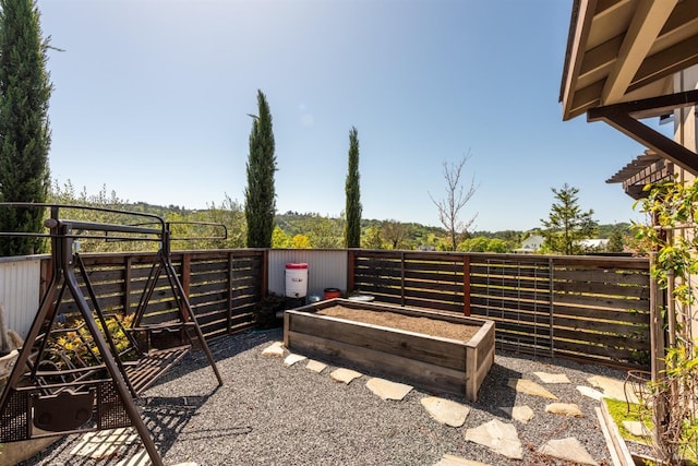 view of yard with a vegetable garden and fence