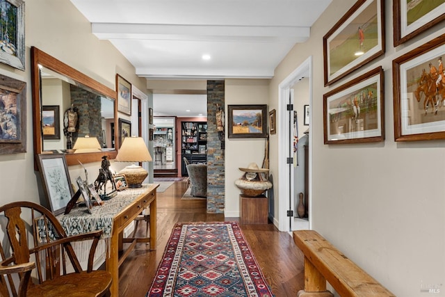 hallway featuring beamed ceiling, baseboards, and dark wood-style flooring