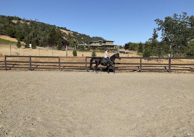 view of yard with a rural view, an enclosed area, and fence