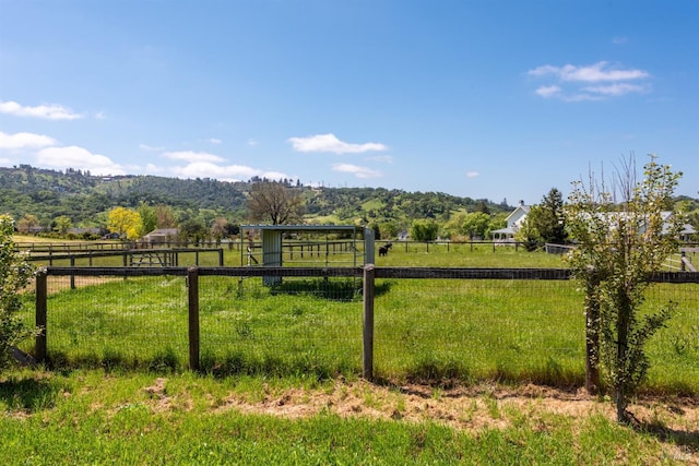 view of yard featuring fence and a rural view