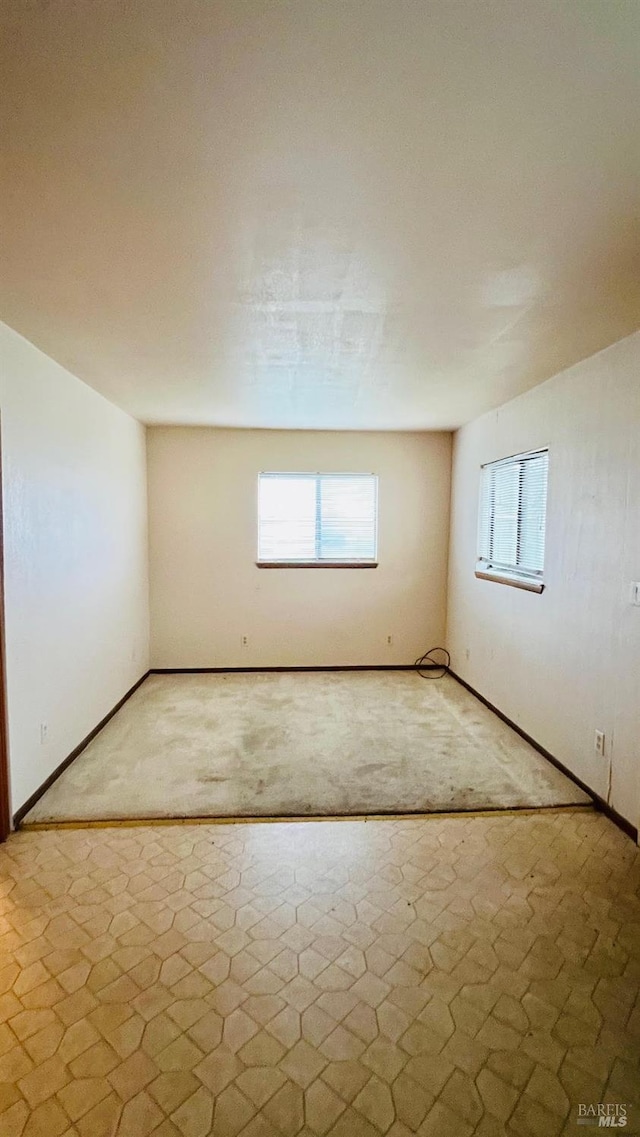 unfurnished room featuring baseboards