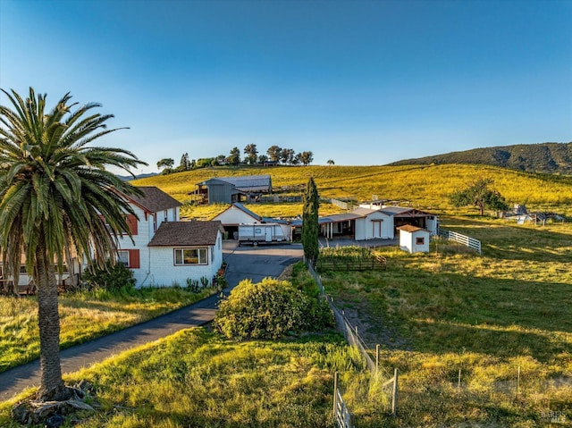 view of front of home featuring a mountain view and fence