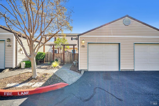 view of front of house with a pergola and fence