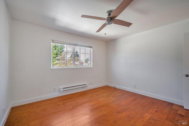 empty room with baseboards, baseboard heating, light wood-style flooring, and ceiling fan