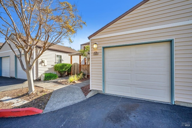 garage featuring aphalt driveway