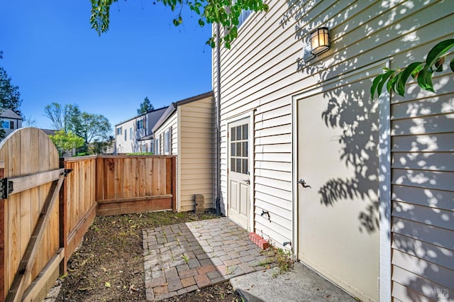 view of property exterior featuring a gate and fence