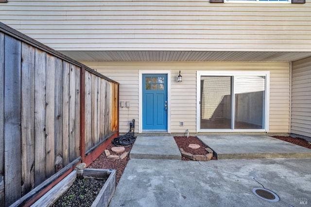 doorway to property with fence and a patio area