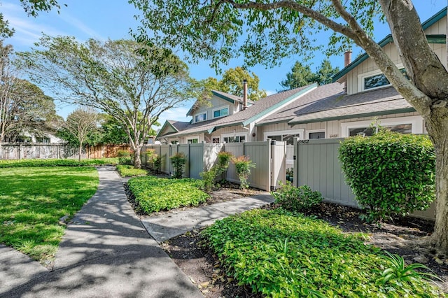 6482 Meadow Pines Ave, Rohnert Park, CA 94928 - view of side of property with a lawn, a gate, a fenced front yard, and board and batten siding