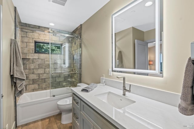 1108 Raymond Ave, Napa, CA 94559 - full bath with visible vents, toilet, enclosed tub / shower combo, vanity, and wood finished floors