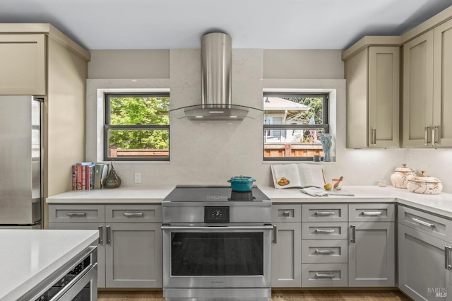 1108 Raymond Ave, Napa, CA 94559 - kitchen with wall chimney range hood, stainless steel appliances, light countertops, and gray cabinets
