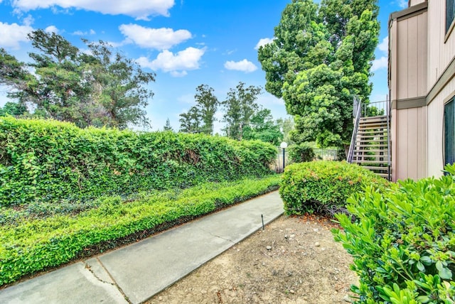 view of yard with fence and stairs