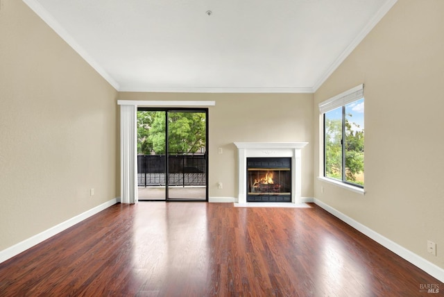 unfurnished living room featuring a fireplace with flush hearth, baseboards, ornamental molding, and wood finished floors