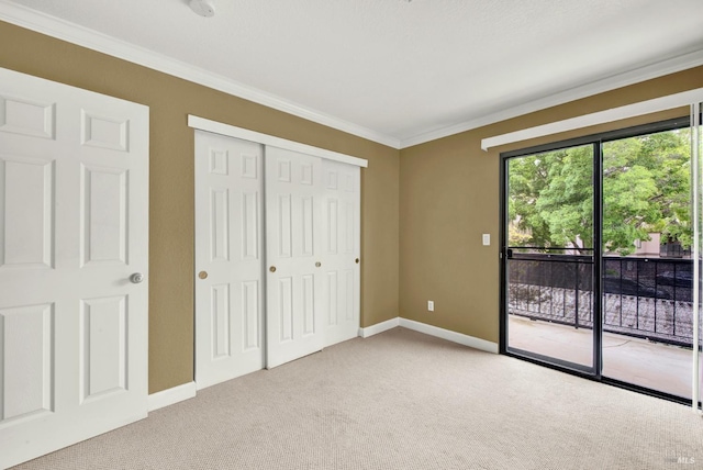 unfurnished bedroom with access to exterior, baseboards, light colored carpet, a closet, and ornamental molding
