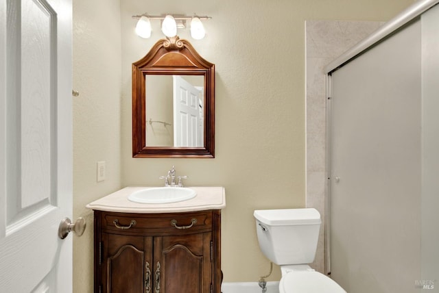 full bath featuring a shower stall, toilet, and vanity