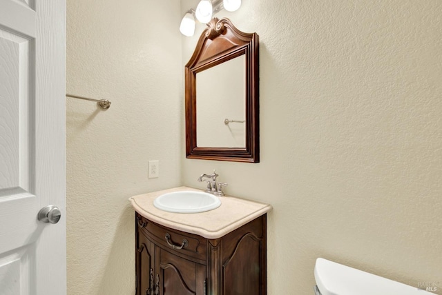 half bathroom with vanity and toilet