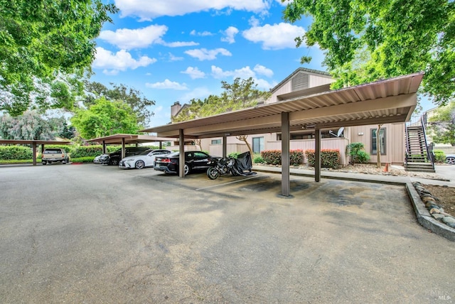 covered parking lot featuring stairs