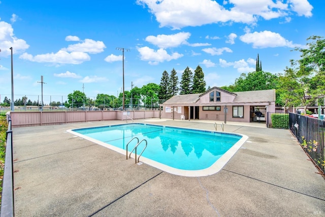 pool featuring fence and a patio