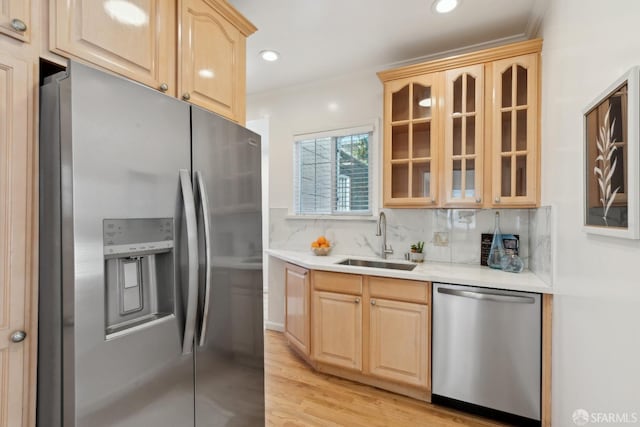 kitchen featuring a sink, light brown cabinetry, stainless steel appliances, and light countertops