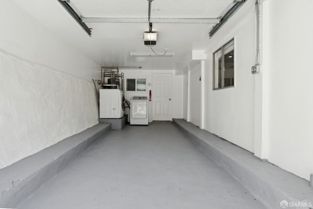 garage with washer and dryer and a garage door opener