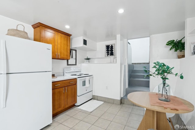kitchen featuring brown cabinets, white appliances, light countertops, recessed lighting, and light tile patterned floors