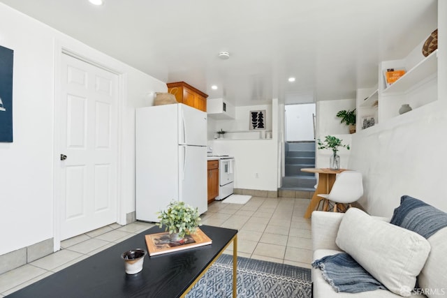 living area featuring recessed lighting and light tile patterned floors