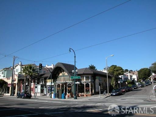 view of street with street lights, sidewalks, and curbs