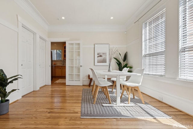 office space with crown molding, french doors, and light wood finished floors