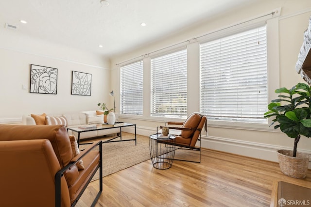 living room featuring recessed lighting, visible vents, a healthy amount of sunlight, and light wood finished floors