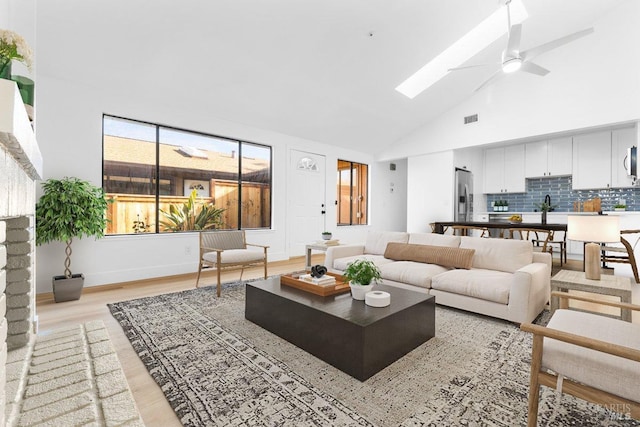 850 E Cotati Ave Unit 13, Cotati, CA 94931 - living area with light wood-type flooring, ceiling fan, a skylight, and high vaulted ceiling