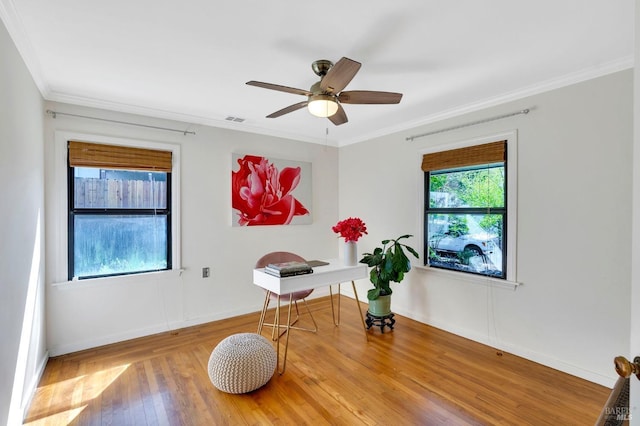 miscellaneous room featuring wood finished floors, baseboards, ceiling fan, and crown molding