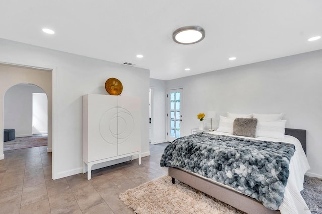 bedroom with arched walkways, recessed lighting, and baseboards