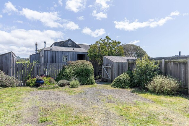 view of yard with an outdoor structure and fence