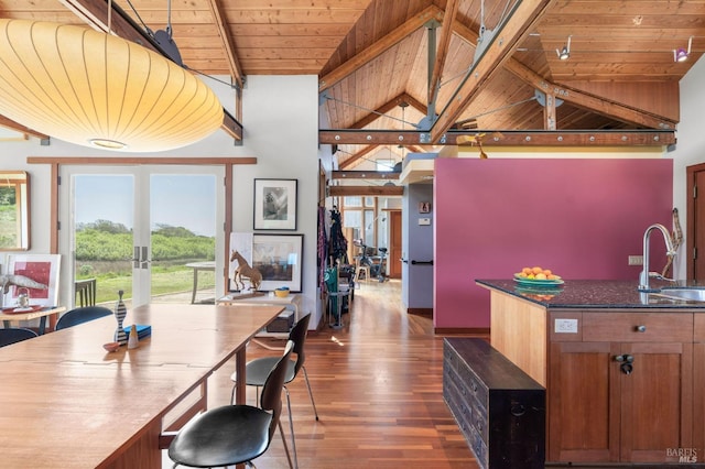 kitchen with dark wood-style flooring, beamed ceiling, a sink, french doors, and wood ceiling