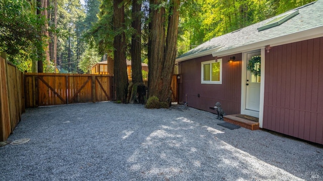 view of yard featuring fence and a gate