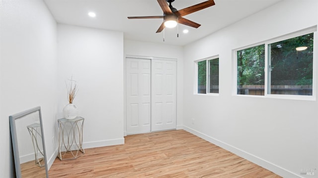 unfurnished bedroom featuring a closet, baseboards, ceiling fan, light wood finished floors, and recessed lighting