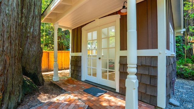 entrance to property featuring french doors and fence