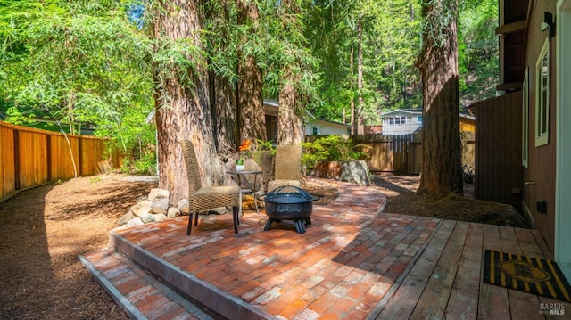exterior space with a fenced backyard, a fire pit, and a patio area