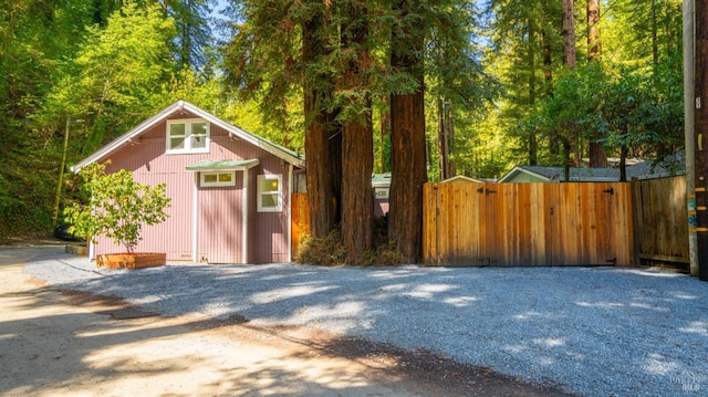 view of outdoor structure with fence and a gate