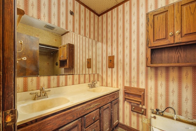 full bathroom with wallpapered walls, double vanity, visible vents, and a sink
