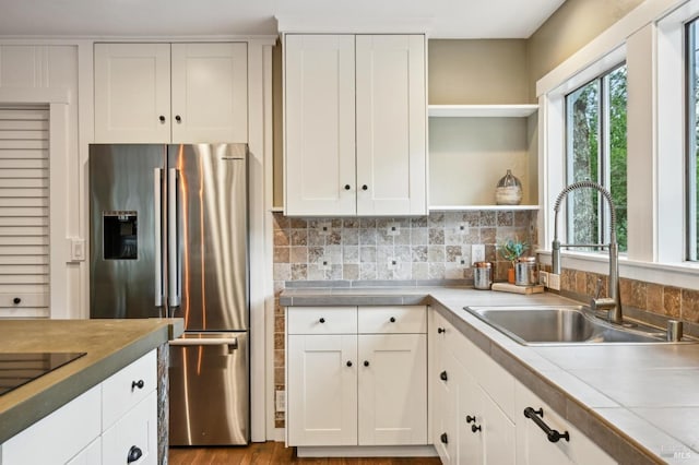 4040 Burnside Rd, Sebastopol, CA 95472 - kitchen with a breakfast bar area, dark wood-style flooring, a sink, tasteful backsplash, and appliances with stainless steel finishes